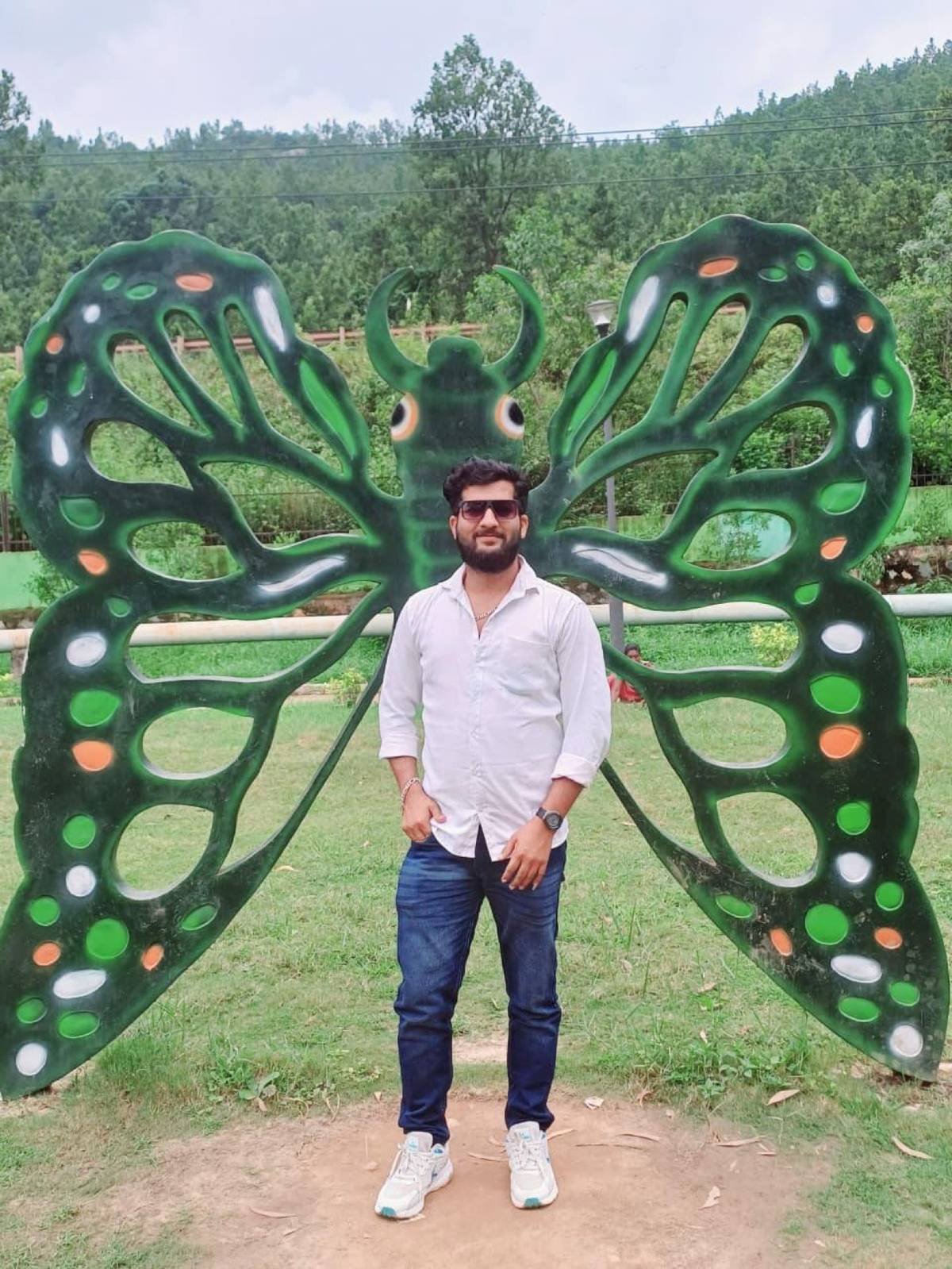 Traveller posing at a butterfly installation, Daringbadi